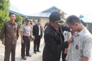 Wakil Bupati Siak Drs. H. Alfedri, MSi sedang menyematkan tanda peserta siswa peduli AIDS di SMA N 1 Sungai Apit